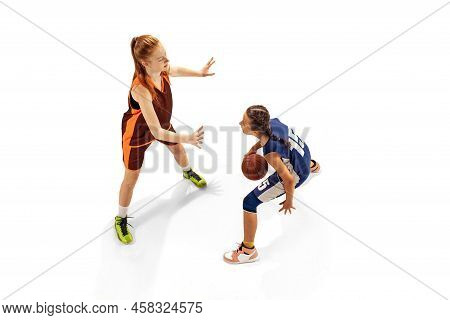 Play Defense. Two Basketball Players, Young Girls, Teen Training With Basketball Ball Isolated On Wh