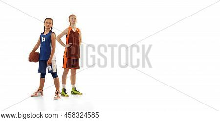 Studio Shot Of Beginner Basketball Players, Young Girls, Teen Training With Basketball Ball Isolated