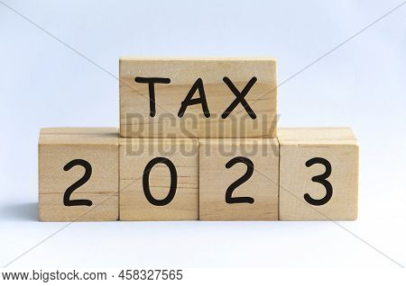 Tax 2023 On Wooden Blocks With White Background. Taxation Concept