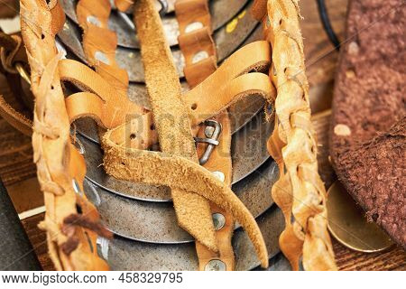 Leather Strap On The Armor Of A Roman Soldier, Close-up. Reconstruction Of Military Events During Th