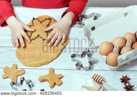 Baby Bakes Gingerbread For Christmas, Homemade Cakes. High Quality Photo