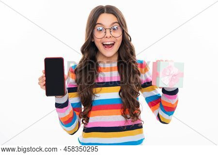 Birthday Present, Bonus For Mobile User. Portrait Of Teenager Child Girl Holding Gift Box And Cell P