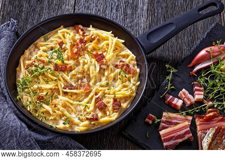 Capunti Pasta In Cream Pecorino Cheese And Pancetta Sauce On Pan On Dark Wooden Table With Ingtredie