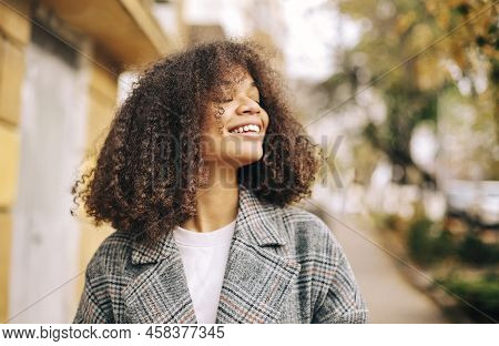 Cute Autumn Close Up Portrait Of Young Smiling Happy African American Woman With Curly Hair Enjoying