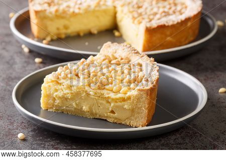 Italian Cake Covered With Pine Nuts Known As Torta Della Nonna Closeup In The Plate On The Table. Ho