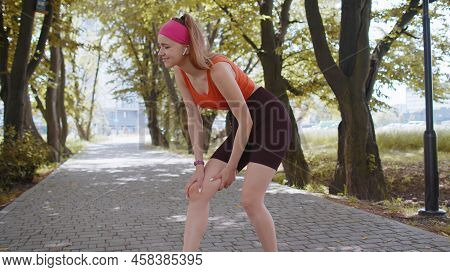 Athletic Fit Runner Girl With Muscle Pain. Young Woman Massaging Stretching, Trauma Injury While Jog