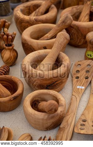 Craft Works On Table, Olive Tree Wooden Kitchen Utensils On Farmers Market In Provence, France