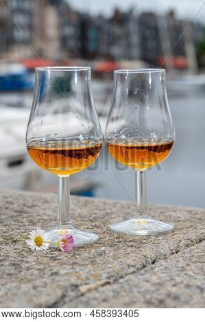 Tasting Of Apple Calvados Drink In Old Honfleur Harbour With Boats And Old Houses On Background, Nor