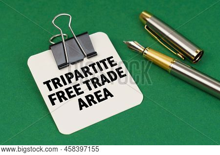 Business And Industry Concept. On A Green Surface, A Pen And A Sheet Of Paper With The Inscription -
