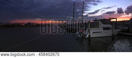 Sunset And Storm Clouds Over The Inter-coastal Waterway And A Marina At  Holden Beach, North Carolin