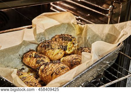 Baked Hasselback Hedgehog Potato With Provence Herbs In The Oven After Baking. French Gourmet Cuisin
