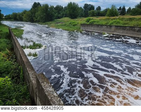 Dirty Brown Foamy Water In The River Nevezis City Panevezys Of Lithuania City Dam