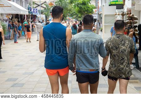 Playa Del Carmen, Quintana, Mexico - February 06.2022 A Homosexual Couple Walking With A Friend Alon