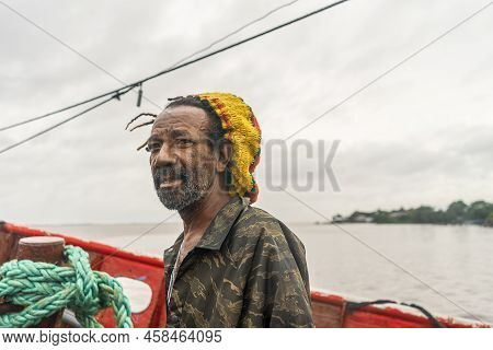 Black Fisherman In The Caribbean Of Nicaragua Riding A Boat And Looking At The Camera