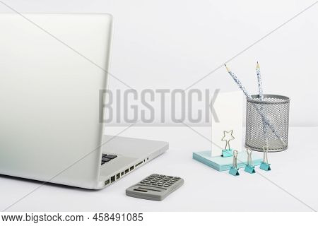 Lap Top, Case With Pencils, Calculator, Paperclips And Sticky Notes Placed On Desk. Computer, Pens, 
