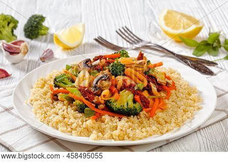 Quinoa Topped With Stir Fried Broccoli, Julienne Carrots, Sun Dried Tomatoes, Leek And Mushrooms On 
