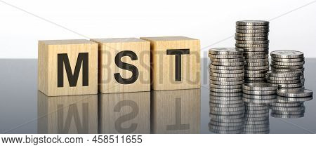 Mst - Text Is Made Up Of Letters On Wooden Cubes Lying On A Mirror Surface, White Background. Stacks