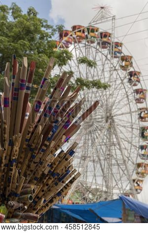 Traditional Bamboo Flutes With Giant Faeries Wheel Background