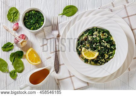 Spanakorizo, Greek Spinach And Rice Pilaf With Lemon, Dill, Scalion In White Bowl On White Textured 