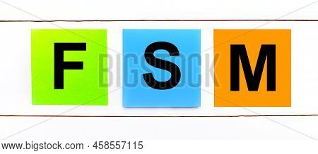 On A White Wooden Background There Are Three Colorful Bright Stickers With Text Fsm Field Service Ma