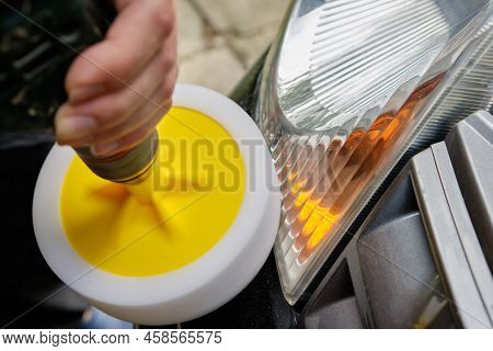 Hands Of A Professional Car Service Male Worker With Orbital Polishing Machine