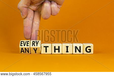 Anything Or Everything Symbol. Businessman Turns Cubes, Changes The Concept Word Anything To Everyth