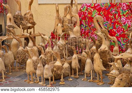 Limoux Aude France 07.22.22 Rows Of Hand Crafted Wooden Ducks And Geese Standing On The Ground. Blac