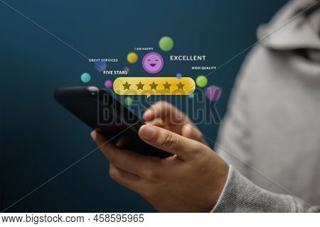 Customer Experiences Concept. Happy Client Using Smartphone To Review Five Star Rating For Online Sa