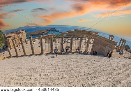 Lindos, Rhodes Island, Greece-july 1, 2022: Ruins Of Large Propylaea And Monumental Staircase In Fro