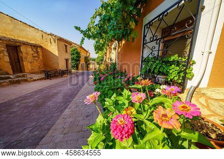Alley With Old Stone Houses And Pots With Flowers Of Multiple Colors, Castilla Leon, Soria.