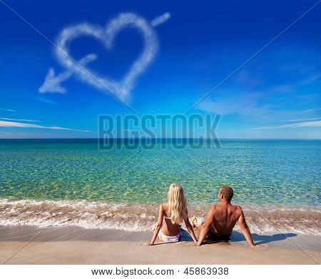 Love Concept - Young Couple On Sea Beach Look At Cloud Heart