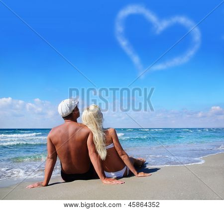 Love Concept - Couple On Sea Beach Look At Cloudy Heart