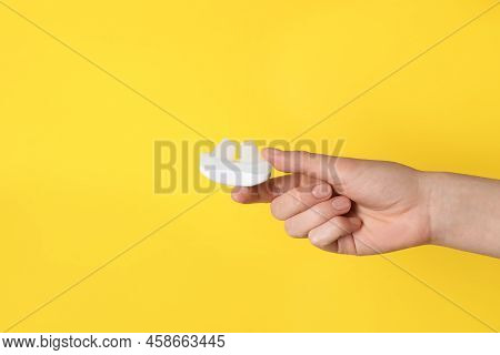 Woman Holding Anti-snoring Device On Yellow Background, Closeup. Space For Text