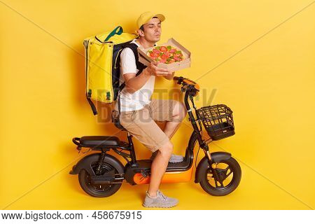 Mmm, How Delicious. Satisfied Delivery Man Enjoys Pleasant Smell From Freshly Baked Pizza On Cardboa