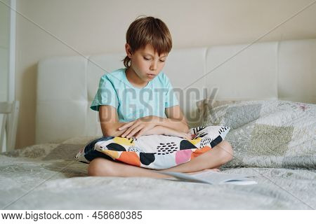 Cute Caucasian Boy Reading A Book Sitting On Bed In Parents Bedroom. High Quality Fullhd Footage