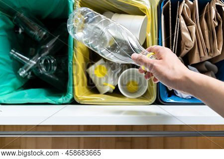 Recycling Concept - Female Sorts Of Plastic, Glass And Paper