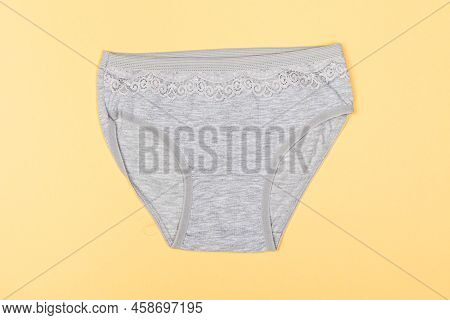 Clothes For Children In The Form Of Panties On A Yellow Background. Clothes For Children From Soft F