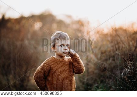 Portrait Of Cute Little Boy Wearing Knitted Sweater In Nautre, Autumn Concept.