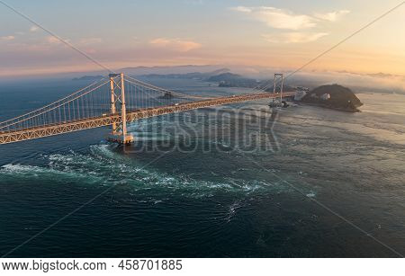 Aerial View Of Strong Current Under Naruto Bridge At Sunset