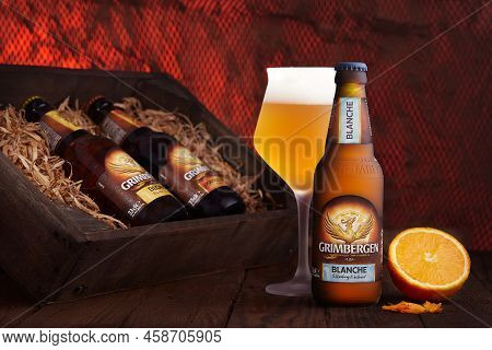 Poltava, Ukraine - July 25, 2022: Bottle Of Grimbergen Blonde Beer. Beer In The Glass.
