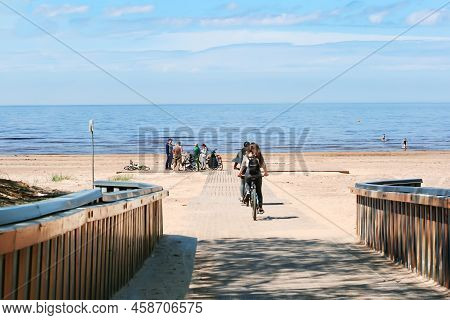 Latvia, Jurmala, June, 2022: Coast Of The Baltic Sea With People Relaxing On The Beach In Jurmala, L