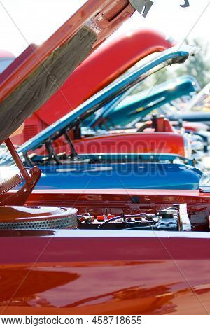 A Line Of Vintage Cars All With Bonnets Raised Showing The Engine Compartments With Selective Focus 