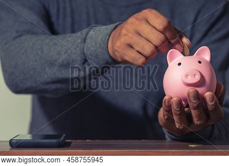 Save Money And Account Banking For Finance Concept, Man With Piggy Bank And Coin On Blurred Backgrou