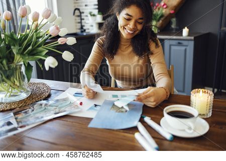 Young Brunette African American Woman Creating Her Feng Shui Wish Map Using Scissors. Dreams And Wis