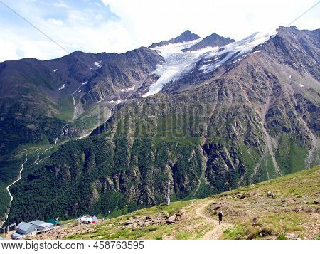 View From Mount Cheget To Mount Elbrus Covered With Snow, The Highest Mountain In Europe, The Caucas