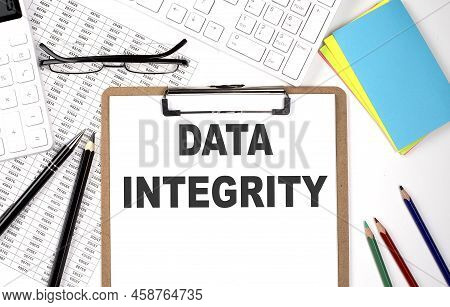 Clipboard With Text Data Integrity And Keyboard And Chart On White Background.