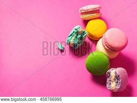 Bright Colorful Various Flavor Macarons Sweet Cookies On High-colored Pink Background.