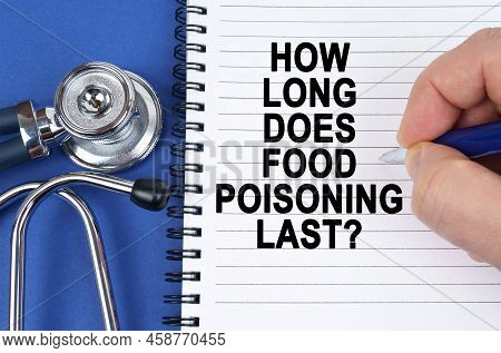 Medical Concept. On A Blue Surface Lies A Stethoscope And A Notebook In Which It Is Written By Hand 