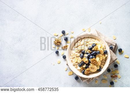 Oatmeal Porrige In Craft Bowl At White Background. Top View.