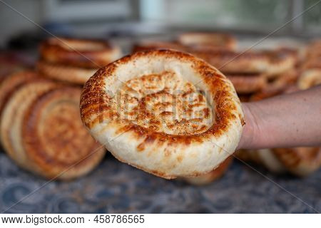 Tandoor Tortilla In The Hand Of The Man Who Baked It. Typical Traditional Flatbread With Crunchy Cru